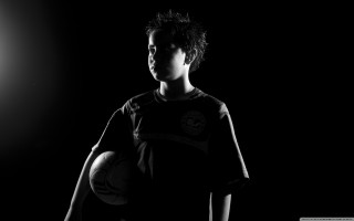 Young man soccer ball dark - his hands in free wallpaper