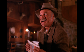 Man hat holding book smiling - twin peak free wallpaper