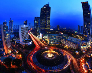 City traffic tall buildings nighttime - basuki abdullah free wallpaper