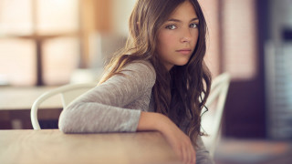 Woman sitting table laptop serious - a laptop computer in front free wallpaper