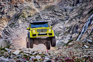 Yellow truck driving rocky area - a yellow truck free wallpaper