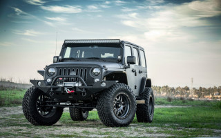 Black jeep parked field grass - a black jeep free wallpaper