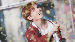 Boy laughing throwing confetti wall - a boy free wallpaper
