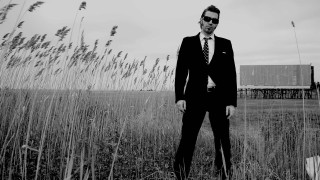 Man suit tie field grass - a barn in the background free wallpaper