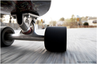 Skateboarder riding street black tire - a black tire free wallpaper