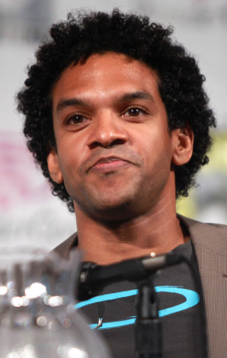 Afrofuturism man blackhair grayjacket water - a black hair free wallpaper for mobile