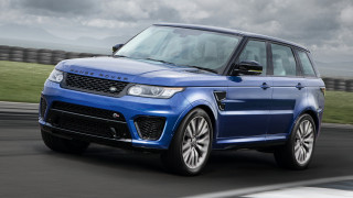 Blue range rover driving cloudy - a grassy area in the foreground free wallpaper
