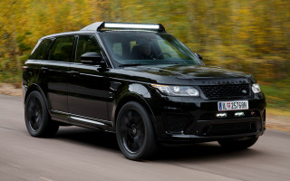 Black range rover driving road - tree and bushes free wallpaper