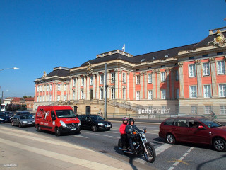 Man motorcycle street building red - a street in front free wallpaper