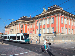 Person riding bike street building - a street in front free wallpaper