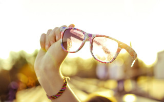 Woman holding glasses sunshine lens - a pair of glasses free wallpaper for desktop