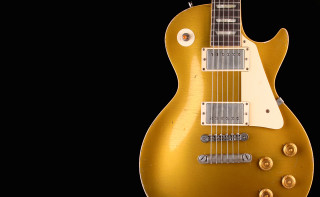Gold electric guitar black background - dusty free wallpaper