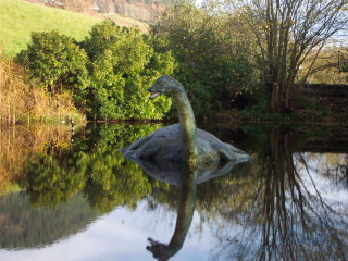 Dinosaur statue lake trees hill - photoreal free wallpaper