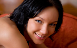 Woman smiling couch red pillow - a red chair free wallpaper