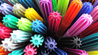Colorful plastic objects circle black - a white center free wallpaper