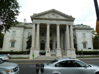 Car parked large building columns - front view free wallpaper