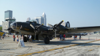 Large propeller plane tarmac city - dieselpunk free wallpaper