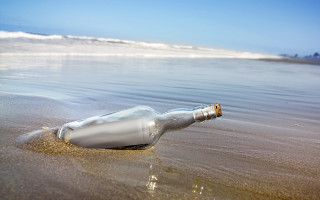 Message in bottle beach shore - a wave free wallpaper