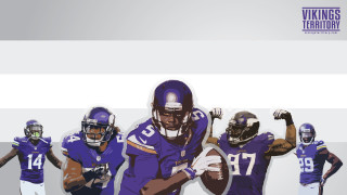 Football players purple uniforms holding - the ball free wallpaper