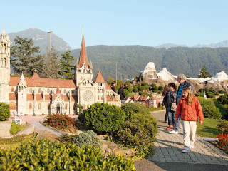 People building clocktower mountain tiltshift - side and a mountain in the background free wallpaper