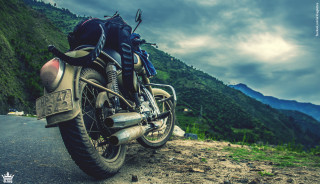 Motorcycle parked road mountain range 2 - a cloudy sky above free wallpaper