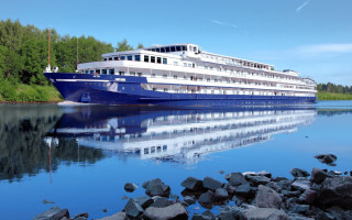 Large boat docked water rocks - erlund hudson free wallpaper