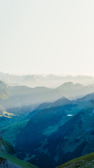 Man riding horse green hillside - free mountains wallpaper for mobile
