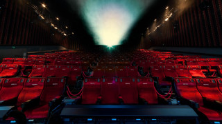 Auditorium red seats projector screen - a large auditorium free wallpaper