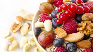 Bowl of fruit and nuts - a spoon and spoon rest free wallpaper