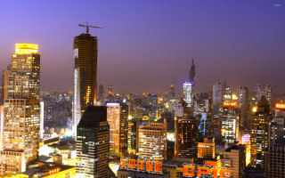 City skyline night cranes buildings - a crane free wallpaper