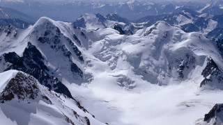 Snowy mountain range aerial view - covered mountain free wallpaper