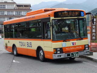 Bus parked road building mountains - a bus free wallpaper