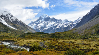 Mountain range stream snow capped - a stream free wallpaper