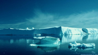 Large iceberg floating ocean distant - a few iceberg free wallpaper