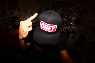 Person hat sticker pointing camera - a sticker free wallpaper