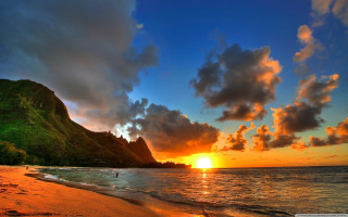 Sunset beach mountain water foreground - a mountain in the background and a body of water free wallpaper