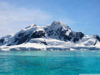 Snowy mountain water blue sky - a small boat free wallpaper
