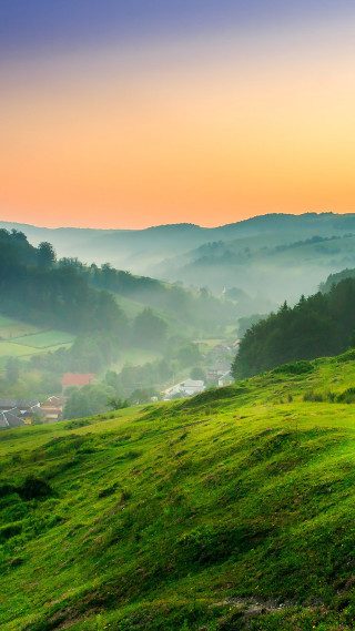 Grassy hill houses sunset fog - free spring wallpaper