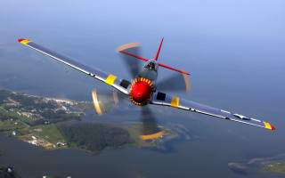 Propeller plane flying water city - a propeller plane free wallpaper