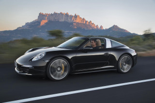 Man driving black porsche mountains - alan sutherland free wallpaper