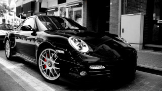 Black porsche parked street building - a black porsche free wallpaper