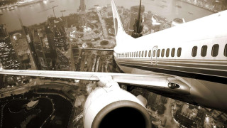 Jetliner night city lights tunnel - over a city free wallpaper