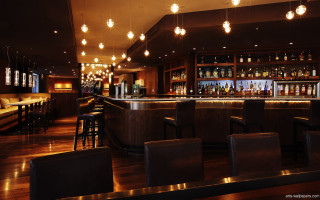 Dimly lit bar stools hanging - bar free wallpaper