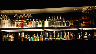 Bar bottles liquor shelves neon - a bar free wallpaper