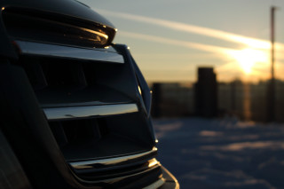 Car parked snow sunset building - the sun setting behind free wallpaper