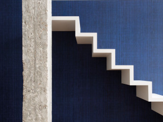White staircase blue walls handrail - a blue wall behind free wallpaper