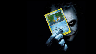 Man holding joker card batman - a batman movie poster free wallpaper