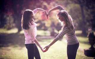 Girls holding hands park trees 2 - a heart shape free wallpaper