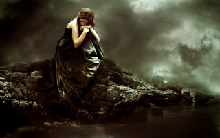 Woman sitting rock water dark - a dark cloud free wallpaper