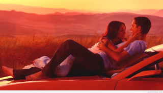 Man woman red car sunset - romantic free wallpaper